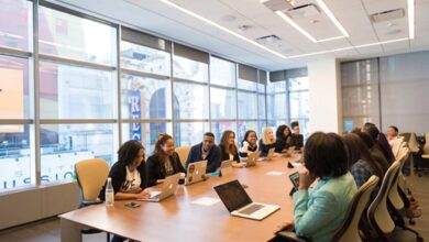 A team in an office discussing proposal management during a meeting