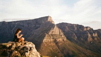 A quiet moment on Table Mountain as a young woman takes in the South African view