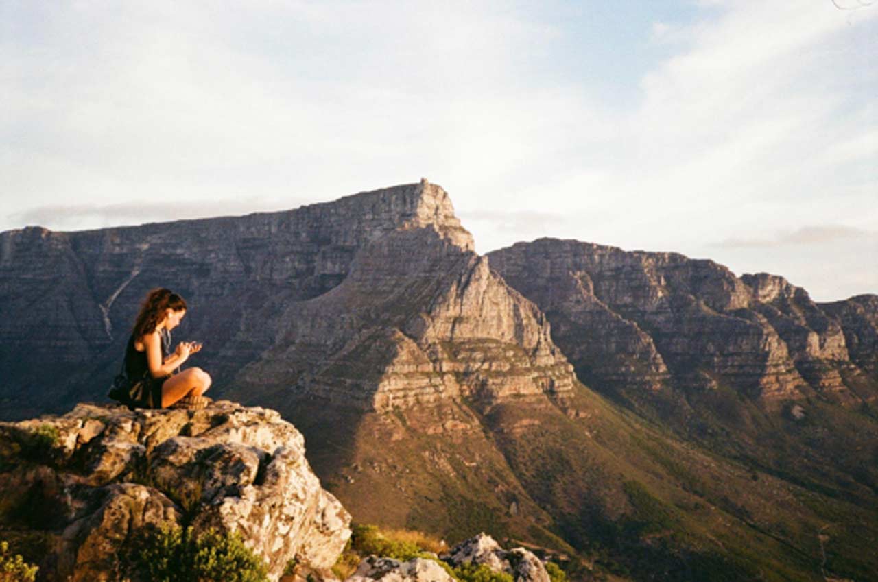 A quiet moment on Table Mountain as a young woman takes in the South African view